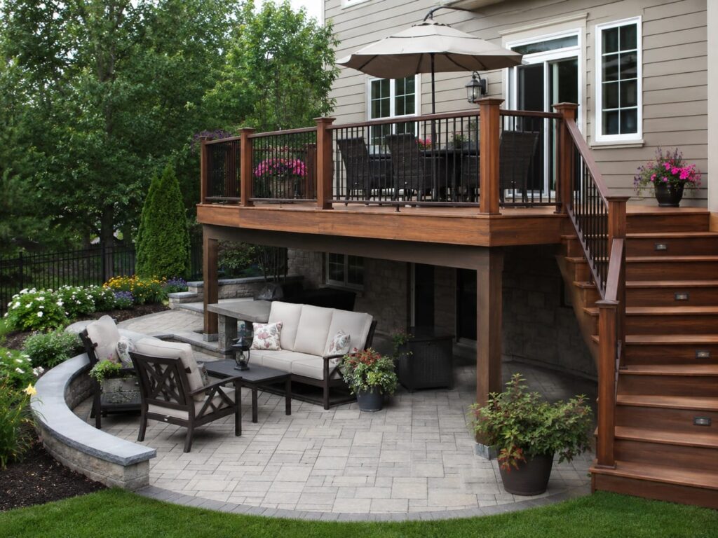 Backyard with raised deck and lower patio outdoor living zones