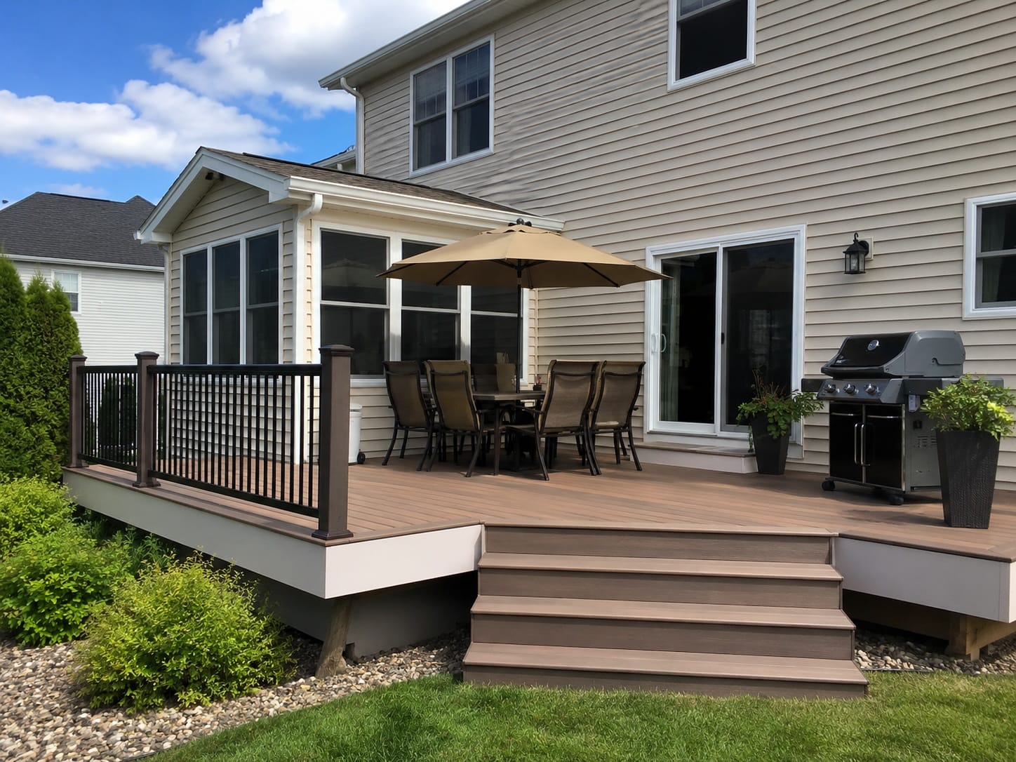 Raised backyard deck with outdoor dining area and grill